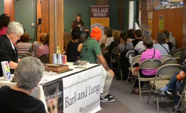 Answering questions at Village Books while Alice serves cake